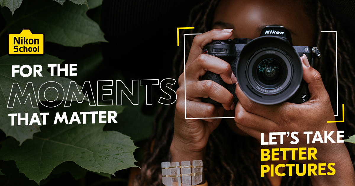 Photographer looking through a Nikon camera